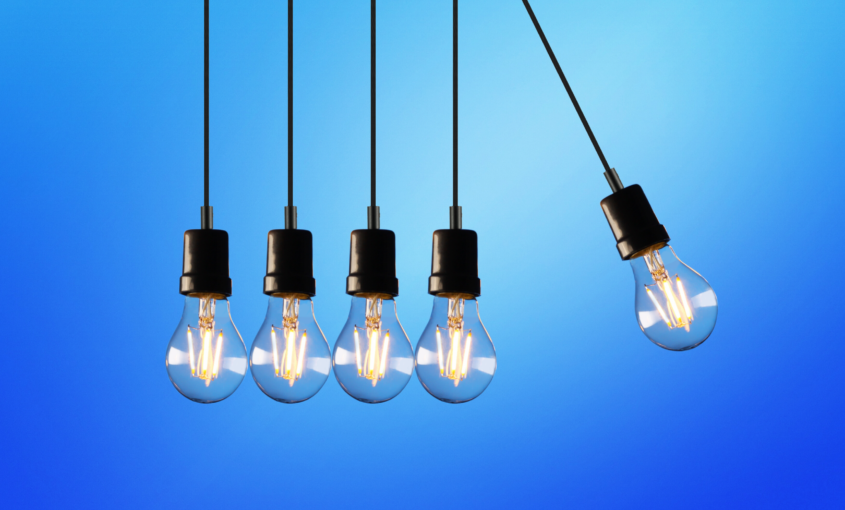 five light bulbs hanging down on blue background